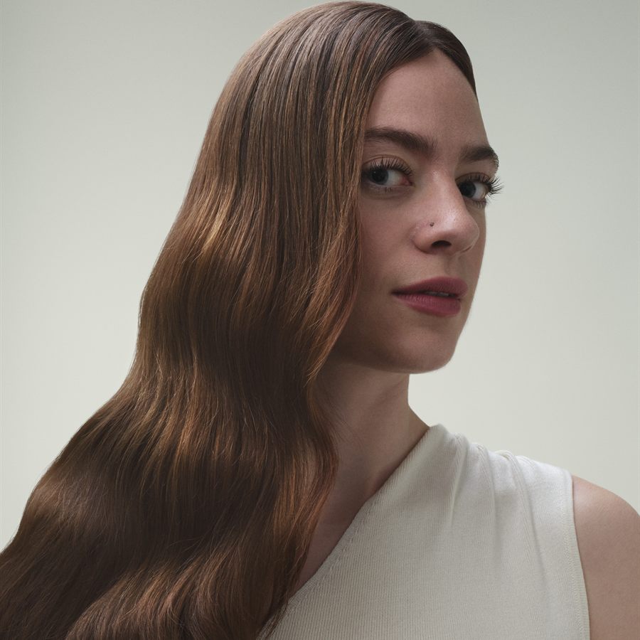 Model with long waved auburn hair in the Russet shade